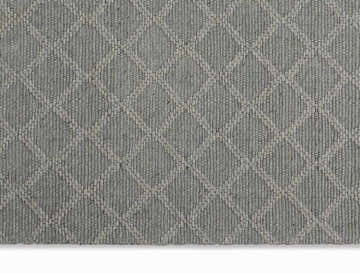 Close-up of the grey Calvin Klein Tallahassee rug. Farmhouse style, with a subtle diamond pattern and woven texture.