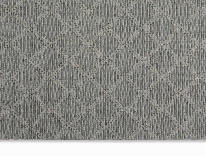 Close-up of the grey Calvin Klein Tallahassee rug. Farmhouse style, with a subtle diamond pattern and woven texture.