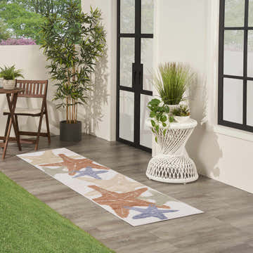 Styled patio with Nourison Aloha Ivory Multicolor Outdoor Area Rug runner featuring starfish design.