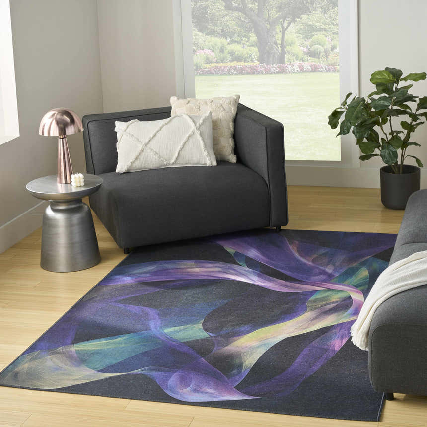 Living room scene with Nourison Blue Multicolor Modern Rug, gray sofa, and natural light.