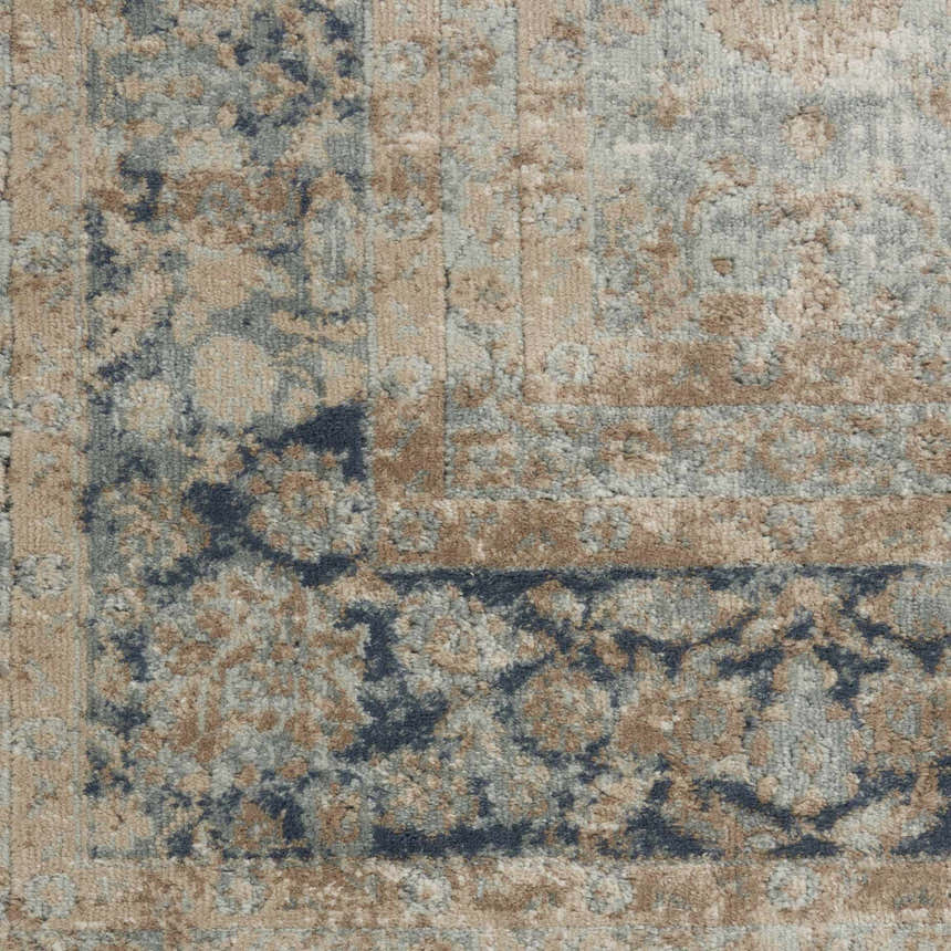Close-up of the Nourison Malta Cloud Vintage Area Rug showing its cloud, tan, and blue vintage pattern and soft texture.