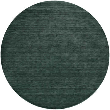 Close-up of a round, hand woven Feizy Luna Modern Solid green area rug. Wool and cotton texture. Design-Round