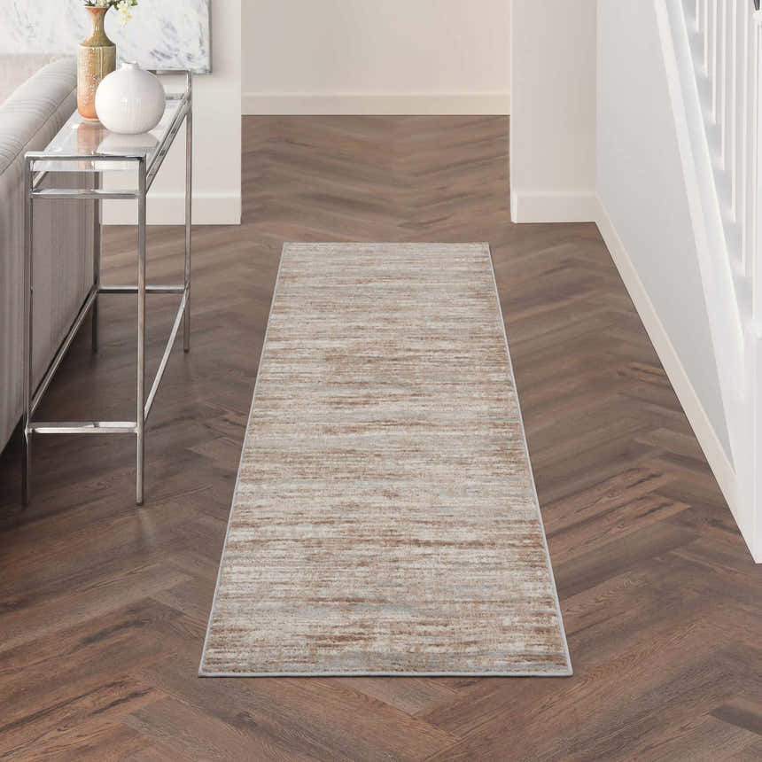 Entryway with Nourison Elation Ivory Grey rug runner on dark wood floors, console table, and neutral decor.