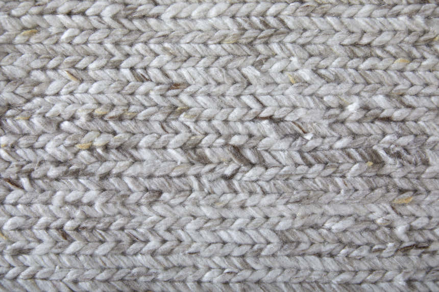 Close-up of the hand-knotted texture of the Feizy Finley Modern Solid silver gray area rug. Texture