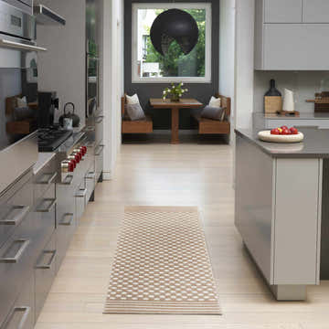 Modern kitchen with stainless steel appliances and Nourison Care Free Brown rug runner.