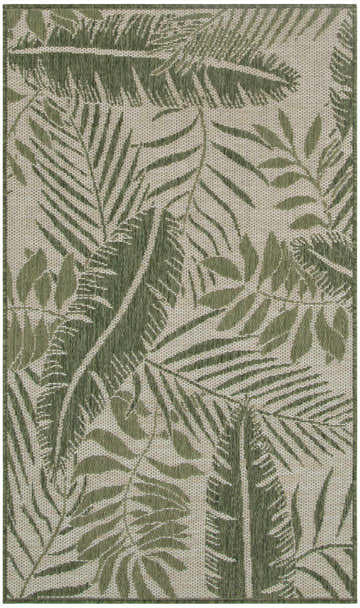Close-up of the Nourison Garden Oasis Ivory Green outdoor rug, featuring a tropical leaf pattern.