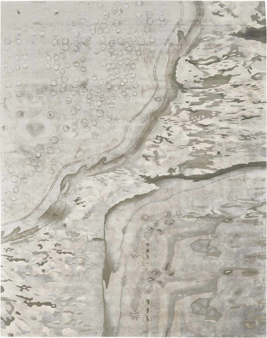 Close-up of the Nourison Prismatic Silver Cloud rug. Abstract design in silver, cloud, and gray tones. Handmade rectangle rug.