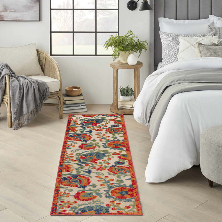 Farmhouse bedroom scene with a Nourison Aloha Red Multicolor runner rug, bed, chair, and natural light.