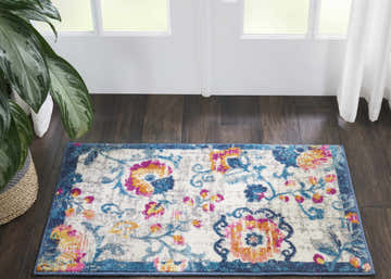Entryway with Nourison Passion Ivory Bohemian rug, floral pattern, blue border, dark wood floor, and white door.