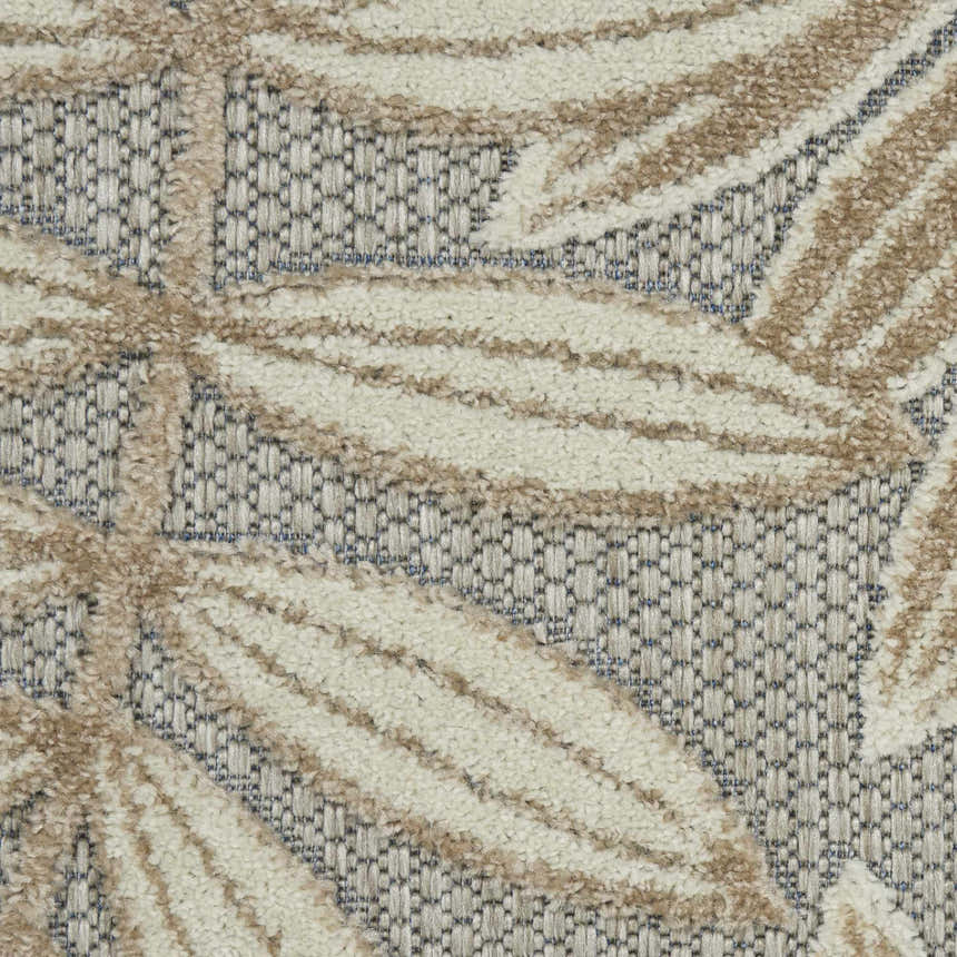 Close-up of Nourison Aloha Natural Tropical Area Rug showing leaf pattern and texture in beige and brown tones.