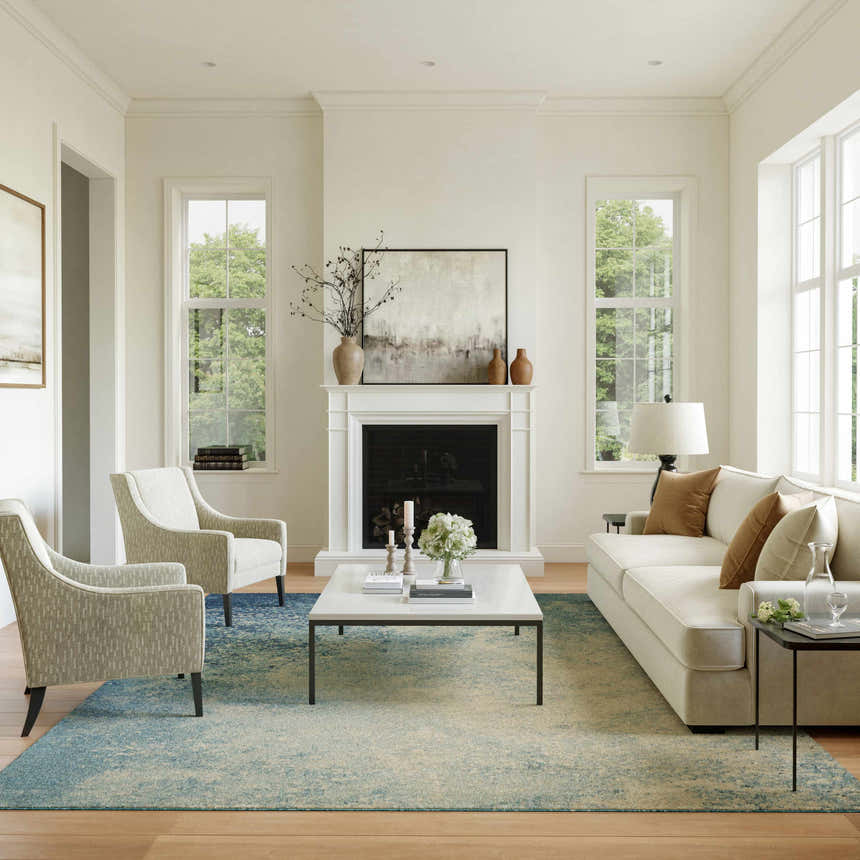 Bright living room with Nourison Passion Navy Light Blue rug, white sofa, armchairs, and fireplace. Modern, airy style.