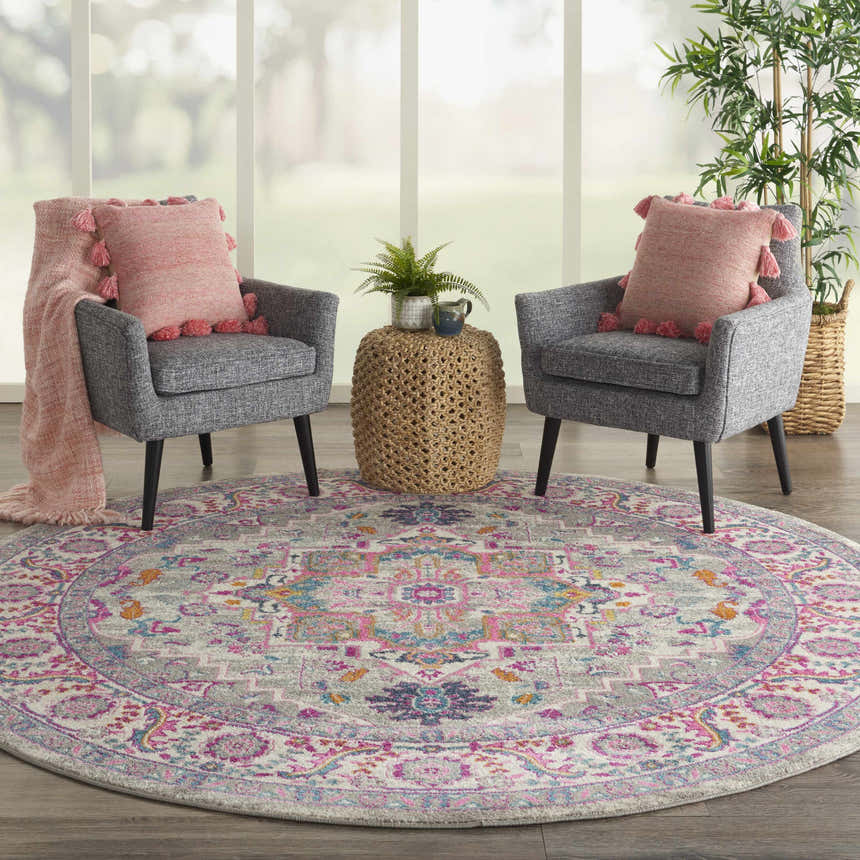 Living room scene with Nourison Passion Light Grey Pink Bohemian Indoor Area Rug, gray chairs, and pink accents.