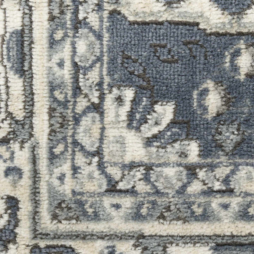Close-up of the Nourison Quarry Navy Ivory rug showing its vintage pattern and textured weave.