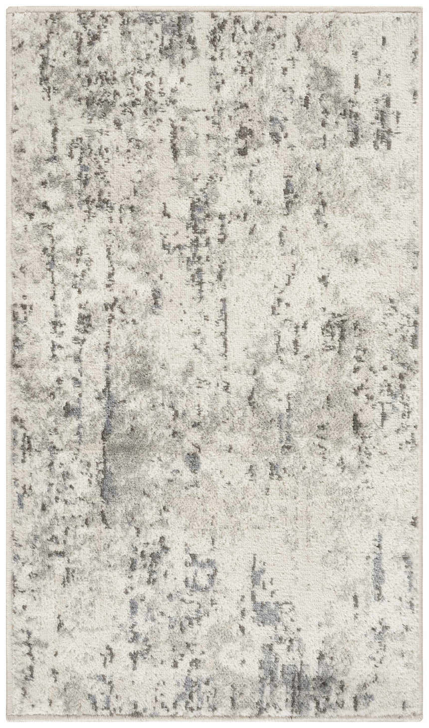 Close-up of the Nourison Quarry Ivory Blue Grey Rug. Abstract pattern in muted ivory, blue, and grey tones. High pile texture.