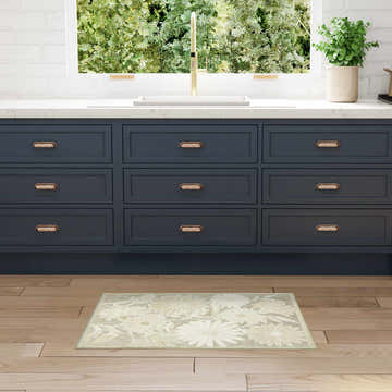 Kitchen scene with dark cabinets and Nourison Aloha Ivory Sage Outdoor Area Rug with floral pattern.