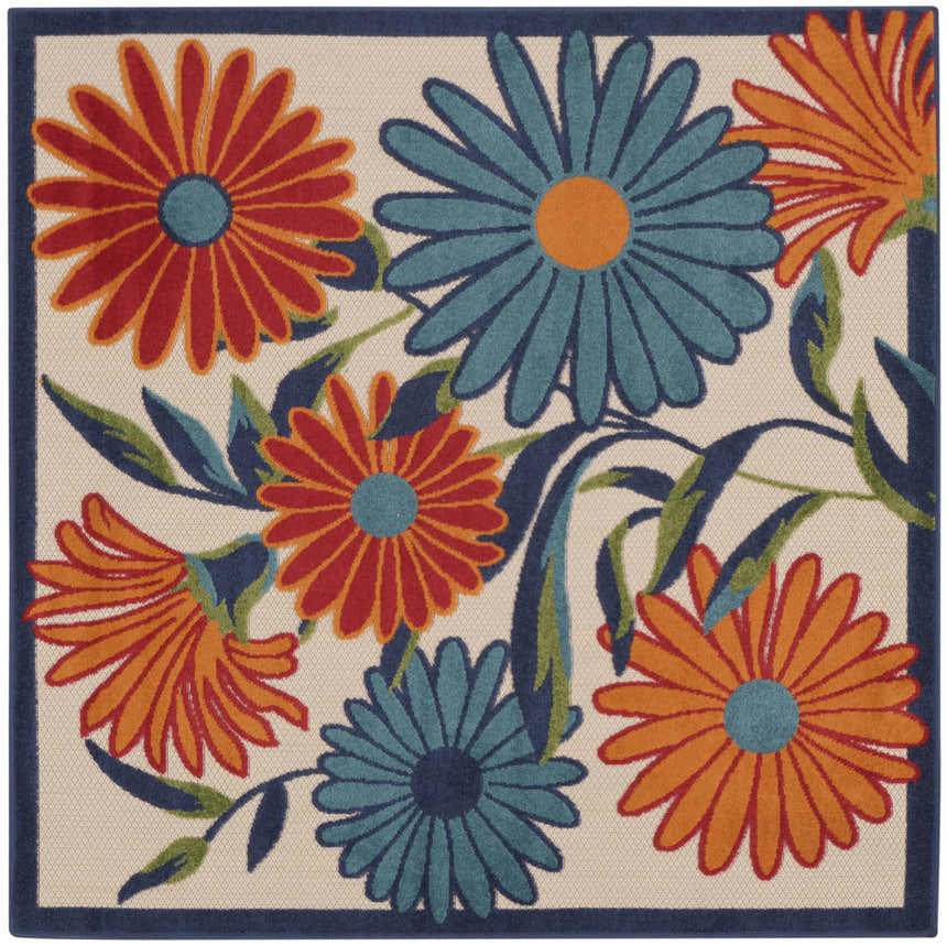 Close-up of Nourison Aloha Multicolor Outdoor Area Rug featuring a floral pattern with orange, red, and teal flowers.