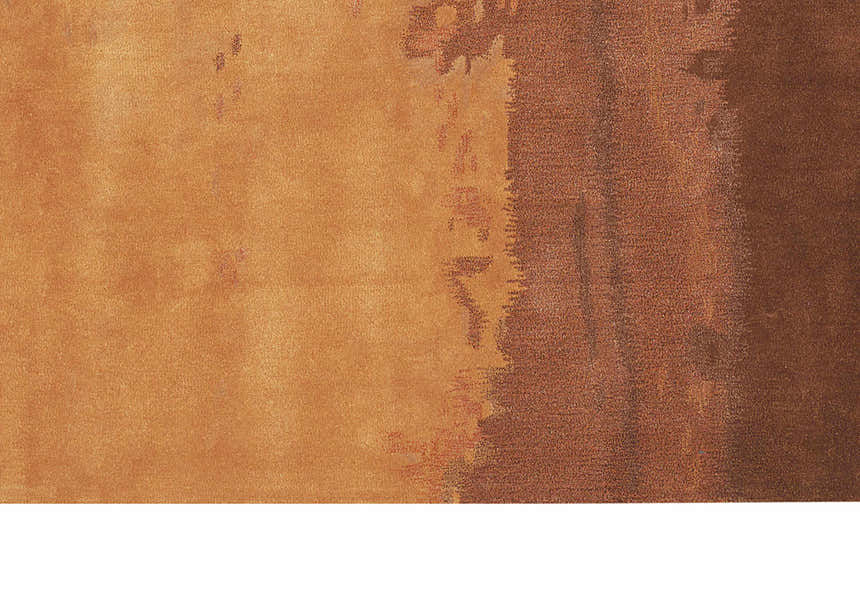 Close-up of the Calvin Klein Home Luster Wash Copper Area Rug, showing caramel color variations and subtle texture.
