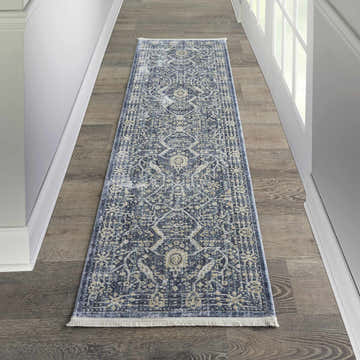 Hallway with Nourison Lustrous Weave Blue Vintage Indoor Area Rug runner on wood floor. White walls and door.