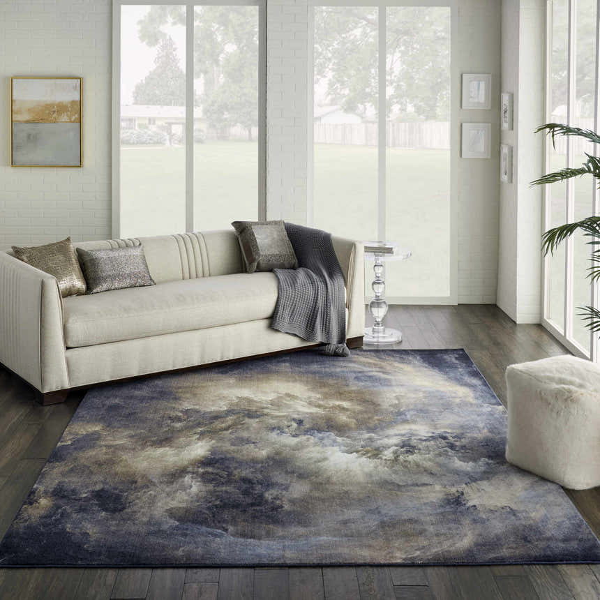 Living room with cream sofa and Nourison Le Reve Chocolate Multicolor rug with cloud-like pattern on dark wood floor.