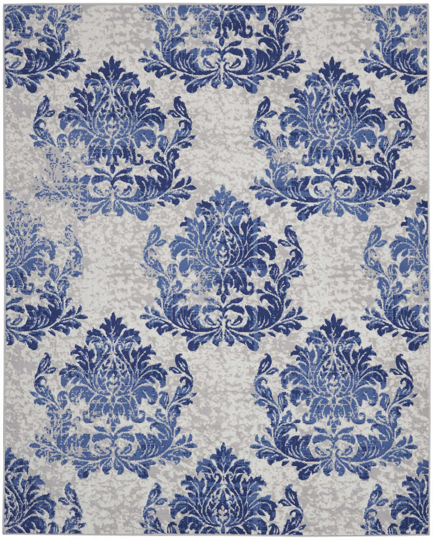 Close-up of the Nourison Whimsicle Ivory Navy rug, featuring a blue damask pattern on a neutral, farmhouse-style background.