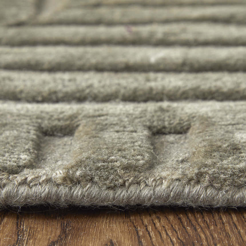 Close-up of the textured, geometric design of the Feizy Channels Green/Taupe/Blue wool area rug. Pile