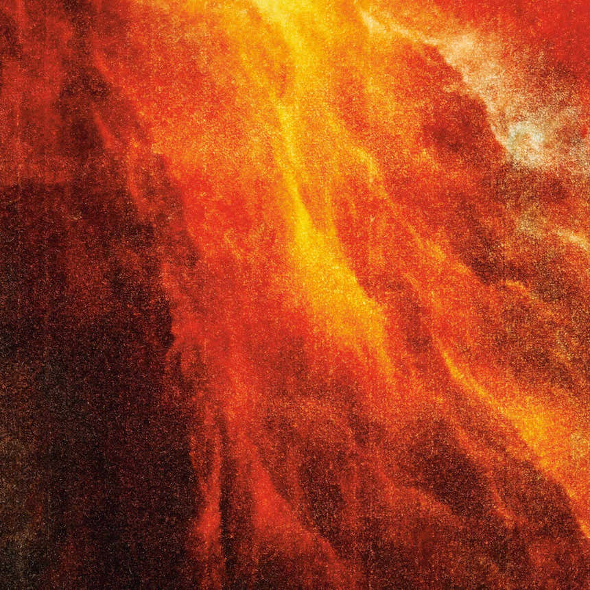 Close-up of the Nourison Le Reve Red/Multicolor rug. Abstract pattern in shades of red, orange, and gold.