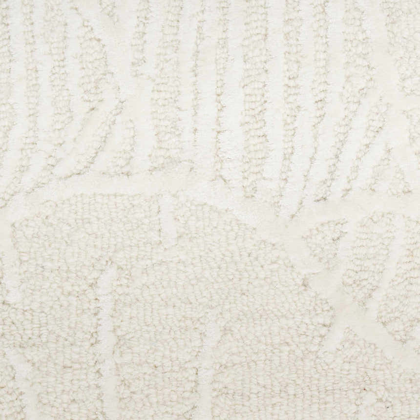 Close-up of the ivory Nourison Avra rug. Shows texture and subtle geometric pattern. Handmade wool rug.
