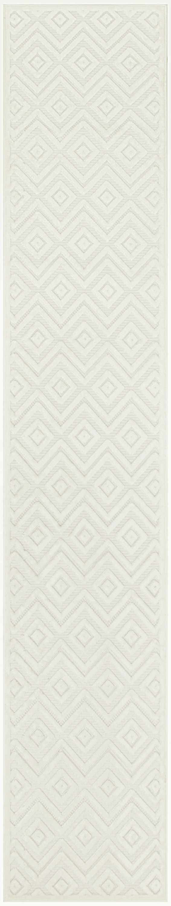 Close-up of Nourison Versatile Ivory White rug. Features a subtle geometric diamond and chevron pattern. Modern style.