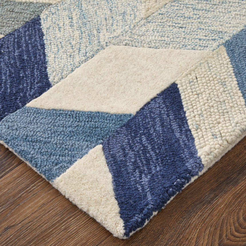 Close-up of the Feizy Arazad rug. Transitional geometric design in blue, ivory, and gray. Hand-tufted texture. Corner