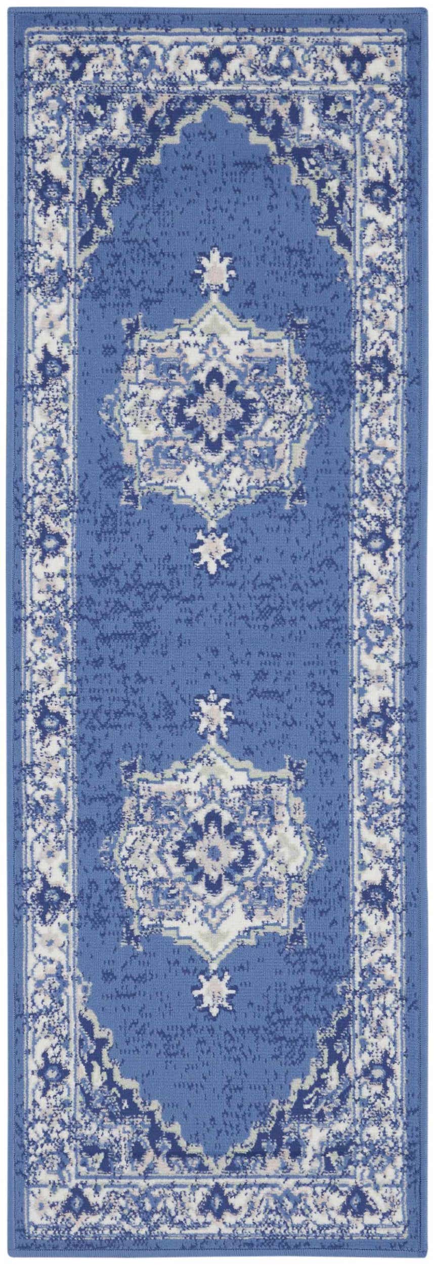 Close-up of the Nourison Whimsicle Navy Farmhouse Indoor Area Rug, featuring a distressed floral medallion design.