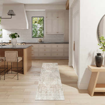 Light, airy kitchen with Nourison Sparkle Grey Mocha rug runner, wood floors, island, and neutral cabinets.