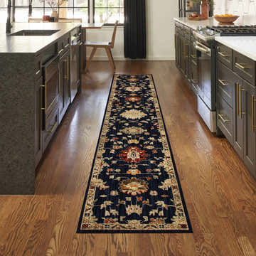 Kitchen scene with a Nourison Antique Bloom Navy vintage runner rug on hardwood floor between dark cabinets.