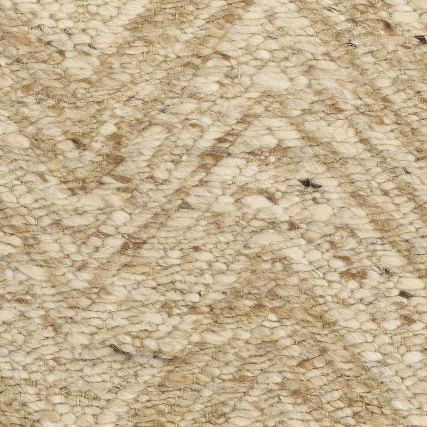 Close-up of the textured weave of the DKNY Pure Purl beige ivory rug. Handmade wool rug with a mid-century modern style.