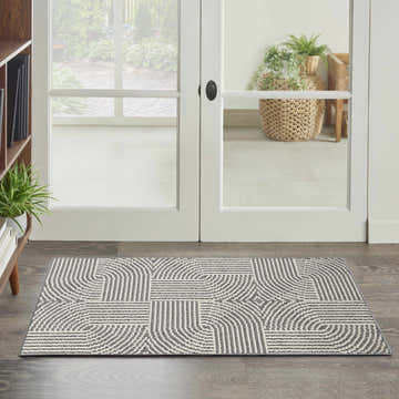 Entryway with Nourison Natural Texture Charcoal Ivory rug, geometric pattern, dark wood floor, and white doors.