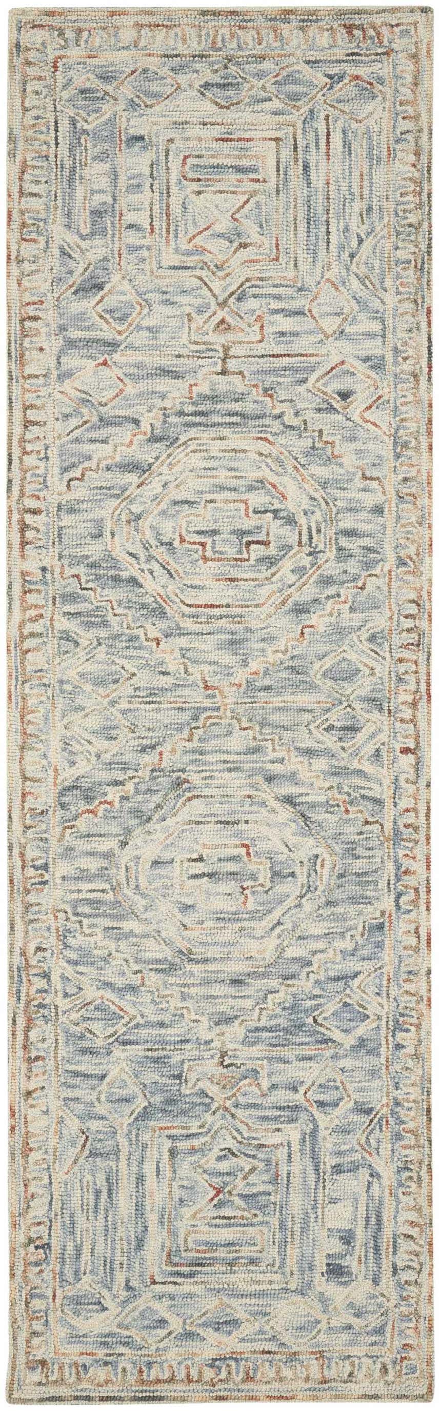 Close-up of the Nourison Interlock Blue Multicolor rug. Features a geometric, bohemian pattern and wool texture.