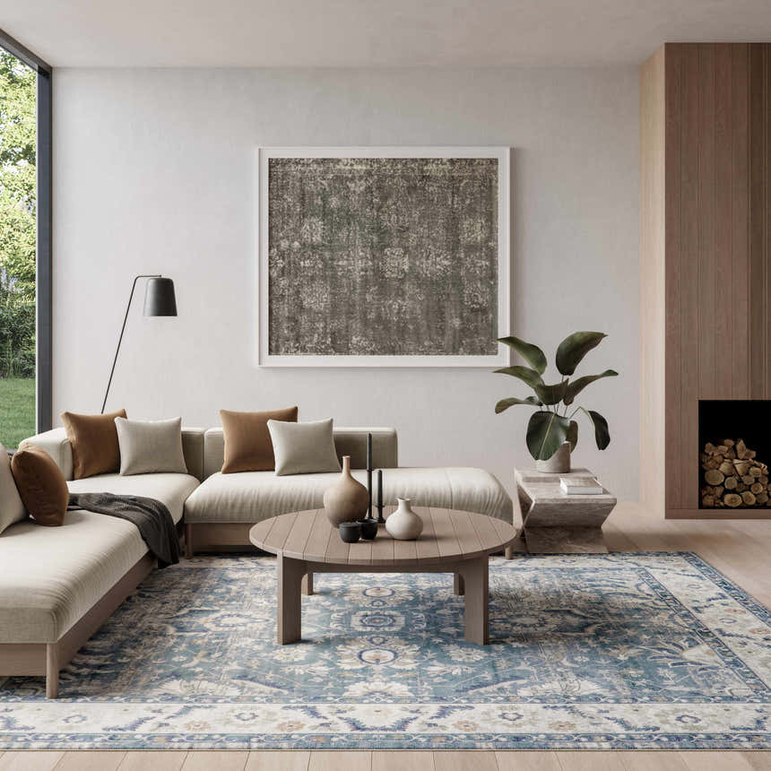 Living room with a beige sofa and the Nourison Astra Blue Vintage Area Rug.