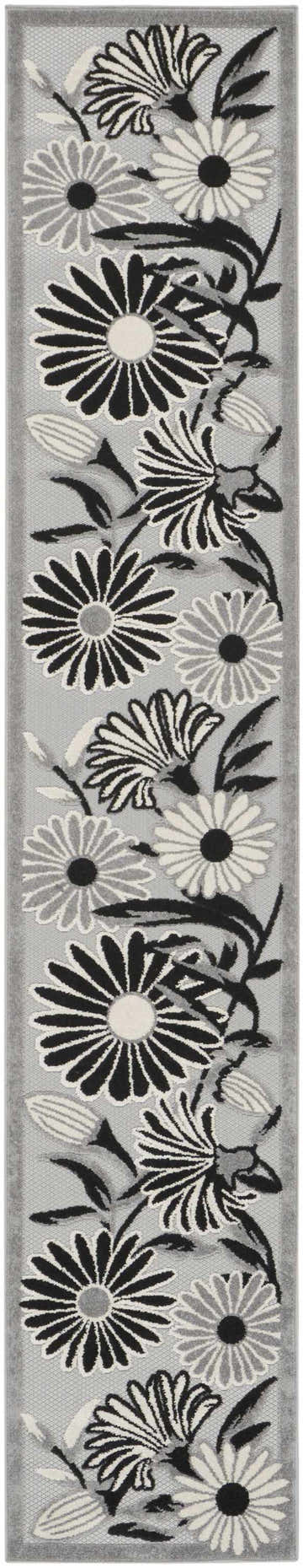 Close-up of Nourison Aloha Black White Outdoor Area Rug featuring a floral design in black, white, and gray.
