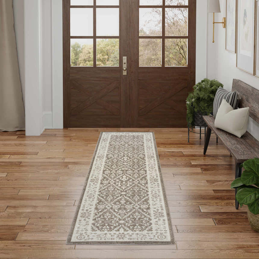 Entryway with Nourison Eco Cycle Ivory Mocha Vintage rug, wood floors, bench, and double doors.