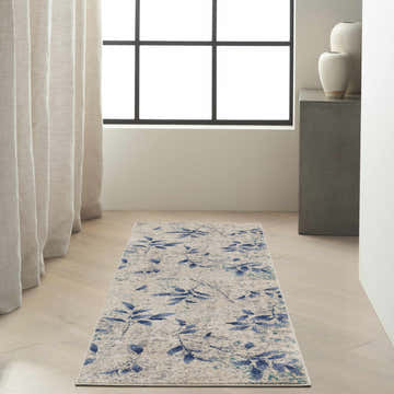 Entryway with beige walls, wood floors, and Calvin Klein River Flow Beige Navy rug.