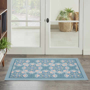 Entryway with Waverly Sun N' Shade Blue Bohemian Area Rug, light blue rug with a floral medallion pattern.