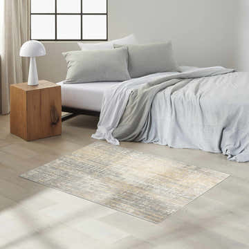 Modern bedroom with grey bedding and Calvin Klein CK005 Enchanting Grey Beige Area Rug on light wood floor.