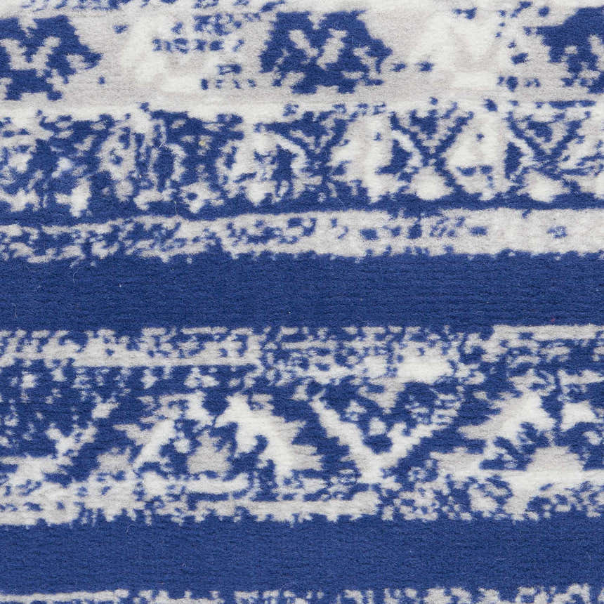 Close-up of Nourison Whimsicle Navy Ivory Bohemian rug. Features a blue and white distressed stripe pattern.