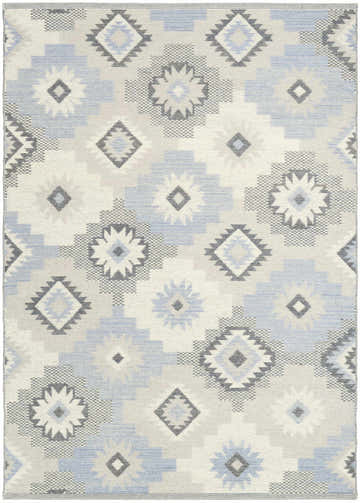Close-up of Nourison Copenhagen Ivory Blue rug with geometric diamond and floral pattern in ivory, blue, and gray.