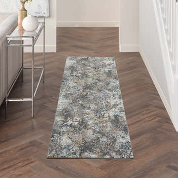 Hallway with Nourison Tangra Grey Multicolor rug, herringbone wood floors, console table, and neutral decor.