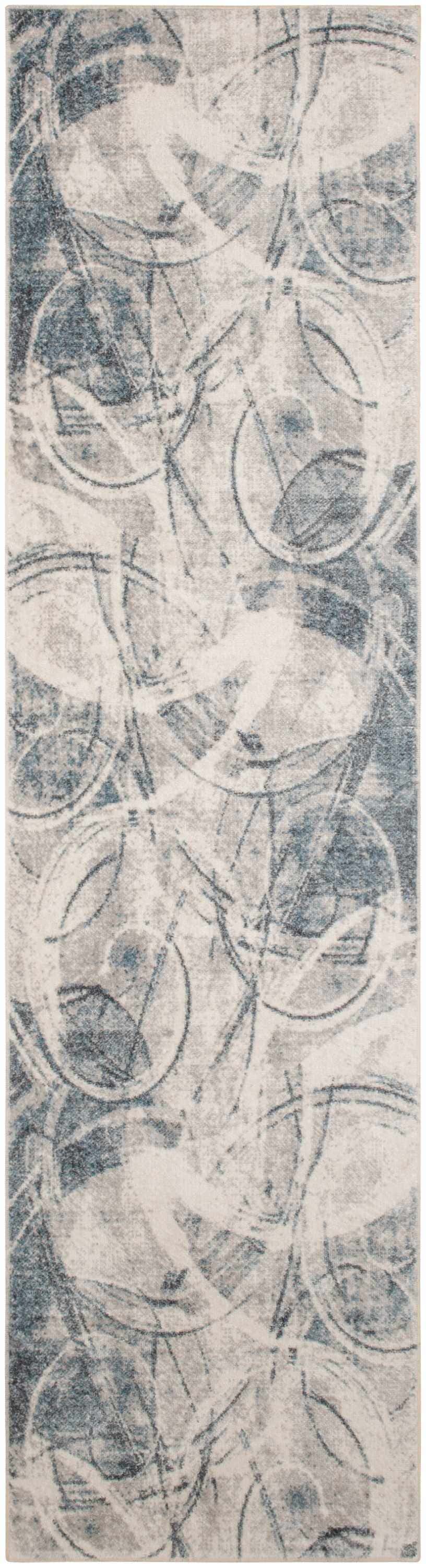 Close-up of Nourison Astra Silver Blue rug, featuring a modern abstract pattern in gray, blue, and white tones.