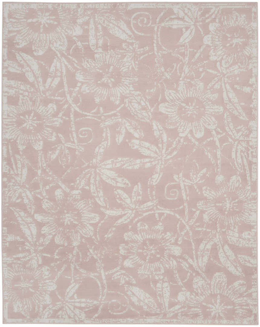 Close-up of a Nourison Whimsicle Pink Farmhouse Area Rug. Features a floral pattern in white against a soft pink background.