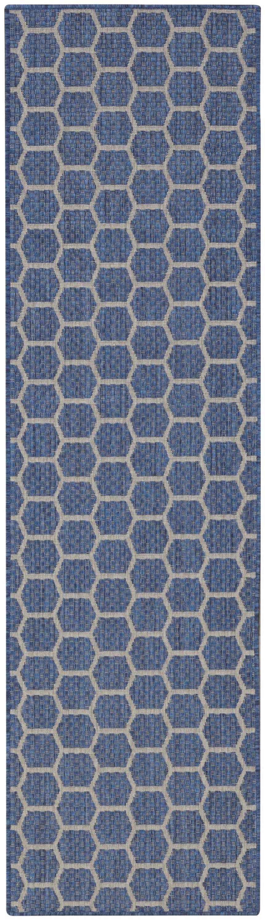 Close-up of the Nourison Twist Reversible Blue Modern Area Rug featuring a blue and gray geometric honeycomb pattern.