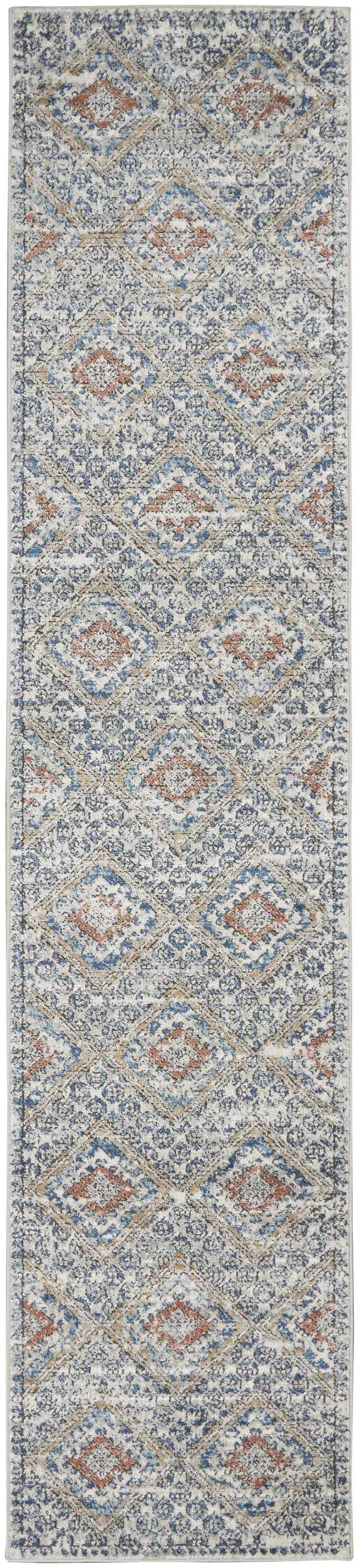 Close up of Nourison Quarry Blue Ivory Southwestern rug, featuring chestnut diamonds and a detailed, distressed design.