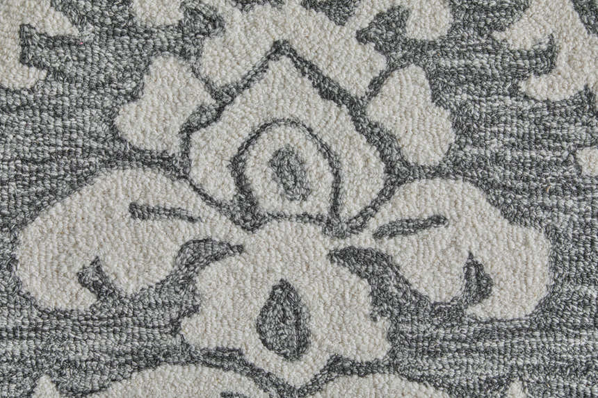 Close-up of Feizy Belfort rug. Gray wool rug with an ivory floral and botanical pattern. Hand-tufted texture. Texture