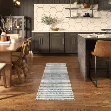 Modern kitchen-dining area with a Nourison Nordic Ivory Blue runner rug on hardwood floors.